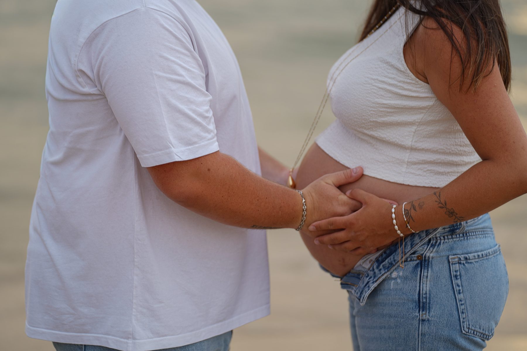Shooting grossesse Noémie et Romain – les mains de Romain autour du ventre de Noémie
